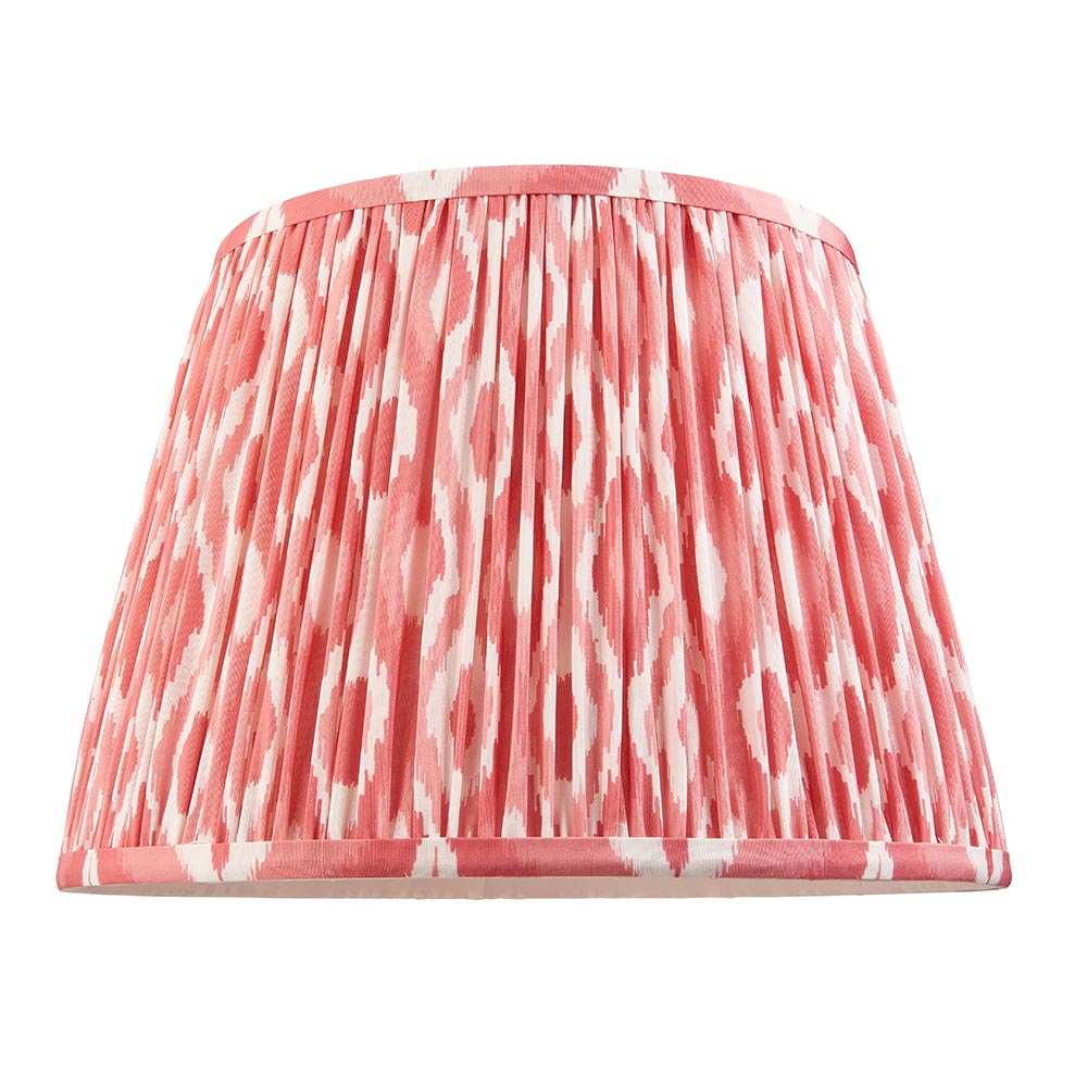 Pleated Ikat lamp shade in coral pink and white patterned fabric with a gathered finish, shown on a plain white background.