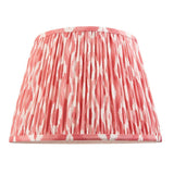 Pleated Ikat lamp shade in coral pink and white patterned fabric with a gathered finish, shown on a plain white background.