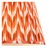 Close-up of the Brenleigh Zigzag Floor Lamp shade in orange and cream, showing handmade gathered pleats and a chevron pattern on faux silk.