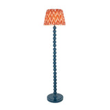 Endon Brenleigh Zigzag floor lamp in marlin blue with stacked sphere metal base and orange zigzag patterned faux silk pleated shade, on a white background.