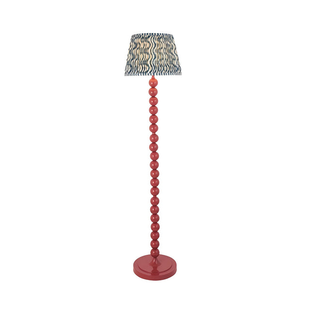 Endon Brenleigh Ripple floor lamp with a coral pink stacked sphere metal base and blue wave-patterned pleated fabric shade, on a white background.