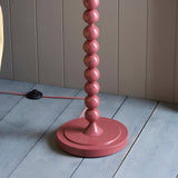 Endon Brenleigh Ivy floor lamp base detail showing glossy pink clay stacked metal spheres on a round base with pink fabric flex and foot switch.