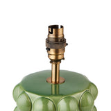 Close-up of the Amberley Ripple Table Lamp's aged brass B22 switched lamp holder atop a green ceramic bobble base, on a white background.