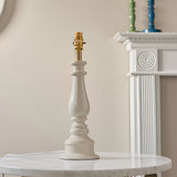 Endon Carlworth Ikat almond gloss resin table lamp base with turned spindle shape and brass B22 lamp holder, on a marble side table.
