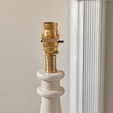 Close-up of Endon Carlworth Ikat Table Lamp II showing brass B22 bayonet lamp holder atop a white gloss turned resin spindle base.