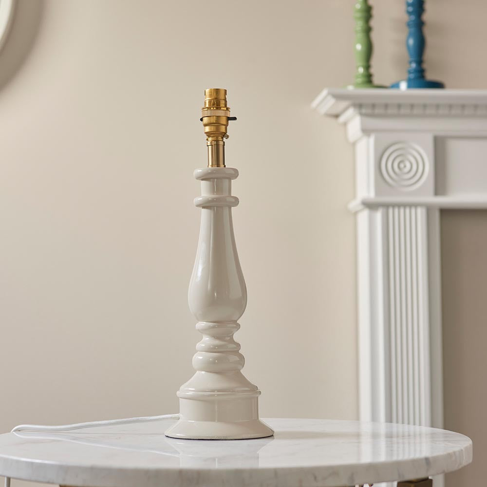 Endon Carlworth Ikat Table Lamp II in almond gloss resin with turned spindle base and brass B22 holder, shown without shade on a marble table.
