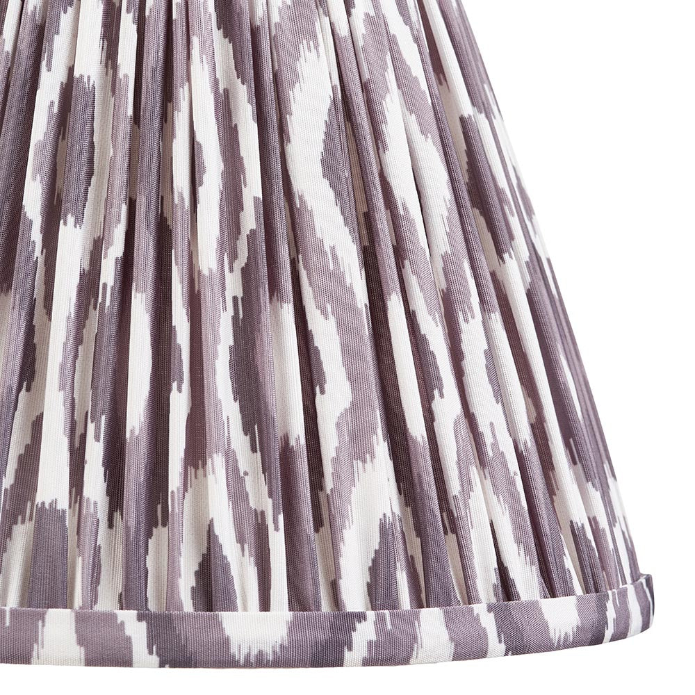 Close-up of the Endon Carlworth Ikat Table Lamp II shade, showing a hand-pleated faux silk drum in almond and grey ikat print.