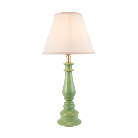 Endon Carlworth Ivy table lamp with a green high gloss turned resin spindle base, brass fitting, and tapered vintage white fabric shade on a plain background.