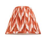 Endon Carlworth pleated tapered lamp shade in orange and white zigzag ikat faux silk with taped edges, shown on a plain white background.