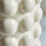 Close-up of the Amberley Ikat Table Lamp's sculptured white ceramic bobble base, showing its textured crackle-glaze finish in detail.
