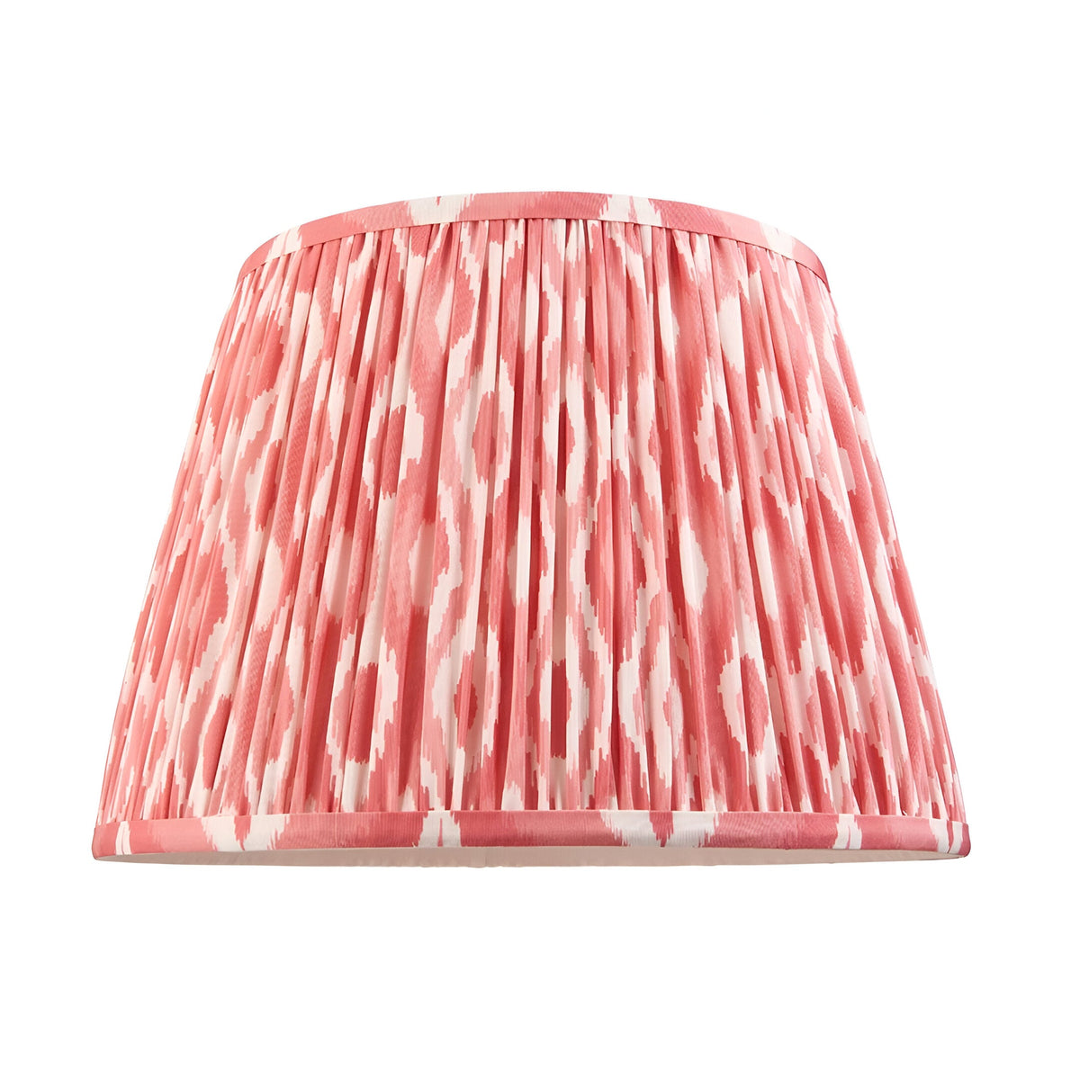 Amberley Ikat Table Lamp shade shown alone in pink and white patterned faux silk with pleated finish and coordinating trim, against a plain white background.
