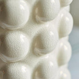 Close-up of the Endon Amberley Ikat table lamp base showing the sculpted white ceramic bobble surface with a gloss crackle glaze finish.