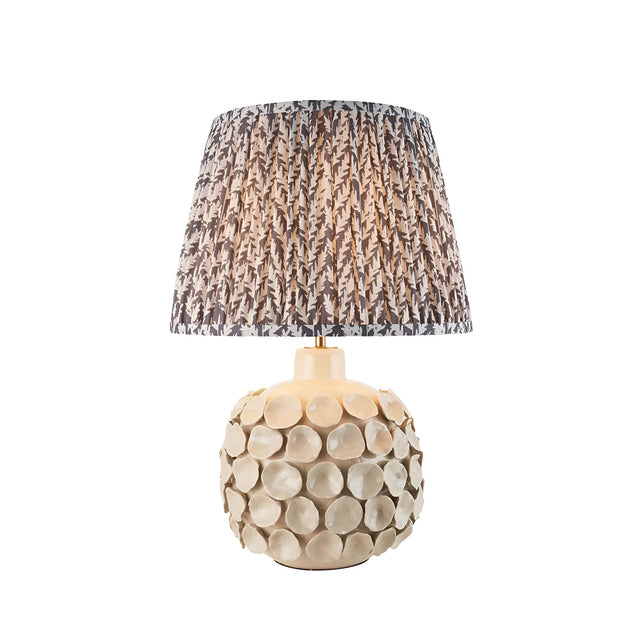 Ashbury Leaf Table Lamp in Grey with a textured ceramic disc base and a pleated tapered shade in grey leaf print, shown on white background.