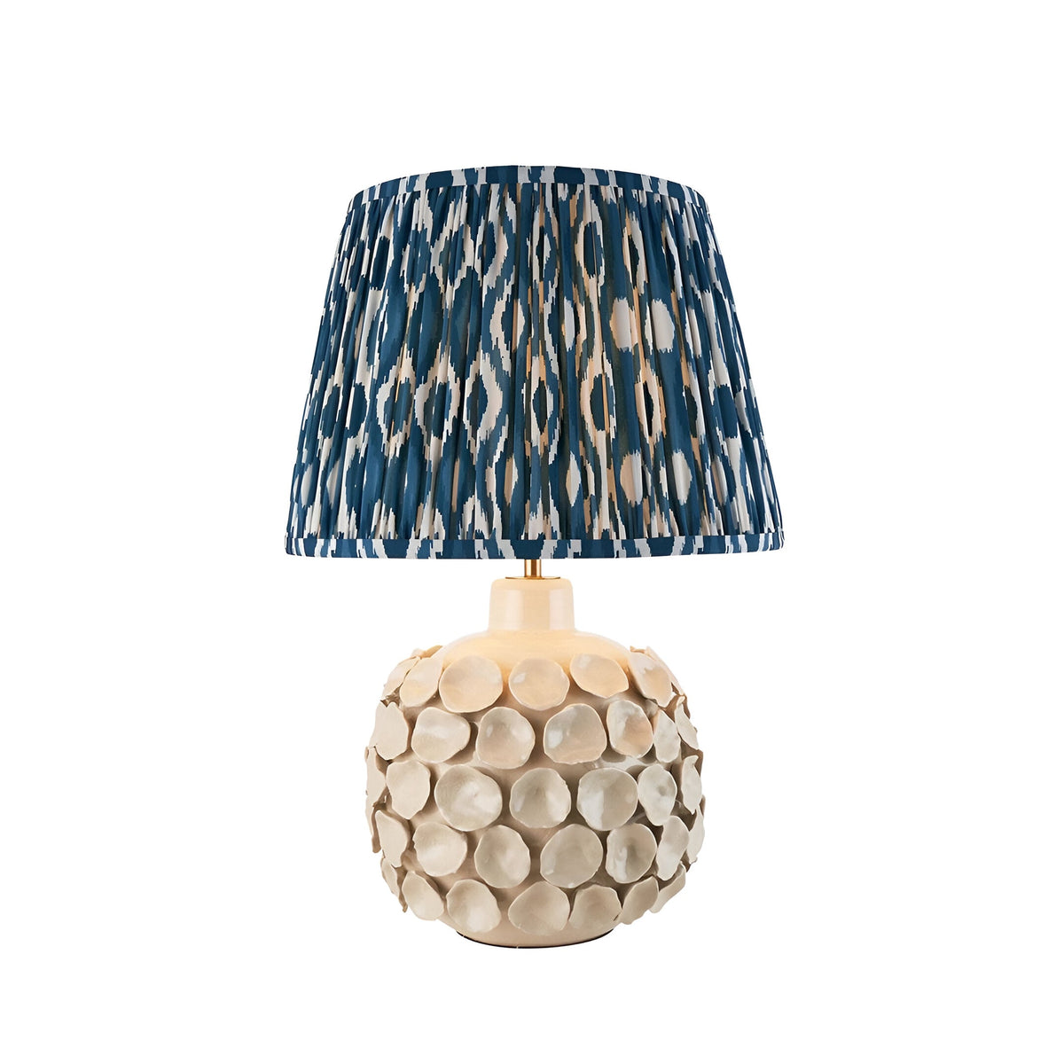 Ashbury Ikat Table Lamp in Blue with pleated blue and cream shade on a round ivory crackle-glaze ceramic base, shown on white background.
