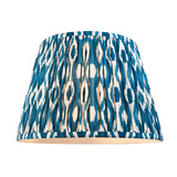 Ashbury Ikat Table Lamp shade in blue, cream and brown patterned fabric with a pleated, gathered design, shown on a plain white background.