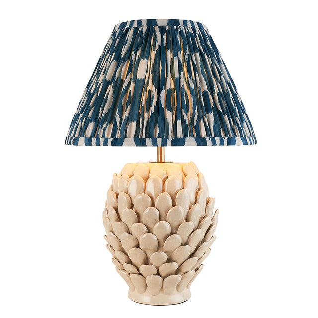 Caldford Ikat 30cm table lamp with cream crackle-glaze leaf-textured ceramic base, brass fittings, and pleated blue and cream patterned fabric shade.