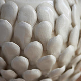 Close-up of the Caldford table lamp base, showing ivory crackle-glazed ceramic with handmade, overlapping leaf-shaped details.