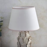 Caldford Ivy 35cm table lamp with ivory crackle-glazed ceramic leaf-detail base and white tapered fabric shade with pink trim.