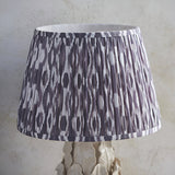 Endon Caldford 35cm table lamp with pleated grey and white Ikat faux silk shade on a sculpted ivory crackle-glaze ceramic base.