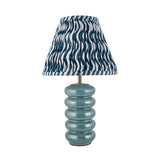 Cliffstead table lamp with ribbed blue reactive-glaze ceramic base, brass fitting, and pleated blue-and-white wave-print fabric shade.