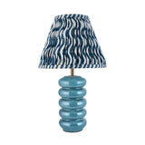 Cliffstead Table Lamp with ribbed blue ceramic base, brass fitting, and pleated blue and white patterned Ripple shade on a white background.