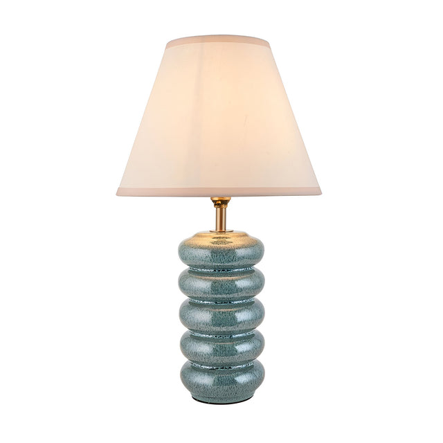 Endon Cliffstead table lamp with a stacked ceramic base in ocean spray blue-green glaze, aged brass stem, and tapered ivory shade on a white background.