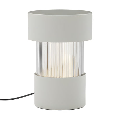 Balise Cylinder Ribbed Glass Lantern Table Lamp in matt white, with iron cap and base framing a fluted glass centre band, shown on a plain white background.