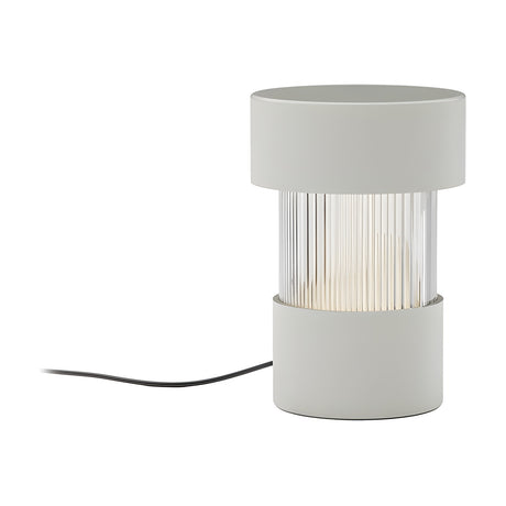 Balise cylindrical table lamp with matt white iron cap and base, ribbed glass centre band glowing softly, black cable, set on a plain white background.