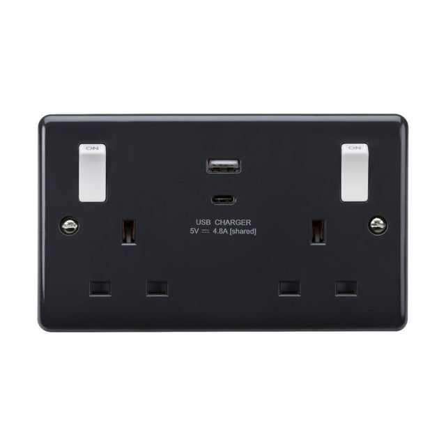 The 13A 2 Gang Switched Socket, featuring white outboard rockers and a dual USB charger, includes two UK plug outlets. Its sleek, modern design is characterized by curved edges and conveniently placed switches beside each outlet, while also offering enhanced anti-microbial properties.