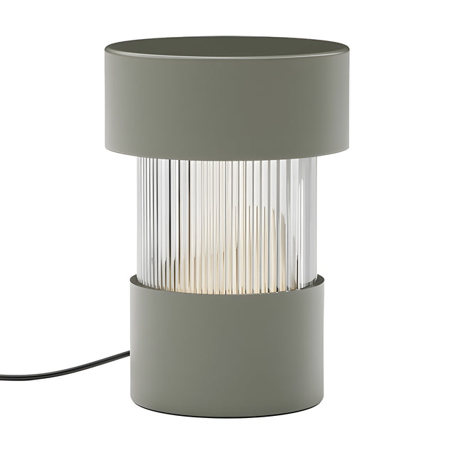 Balise Cylinder Ribbed Glass Lantern Table Lamp in green, with solid iron top and base framing a fluted glass midsection, shown on a plain white background.