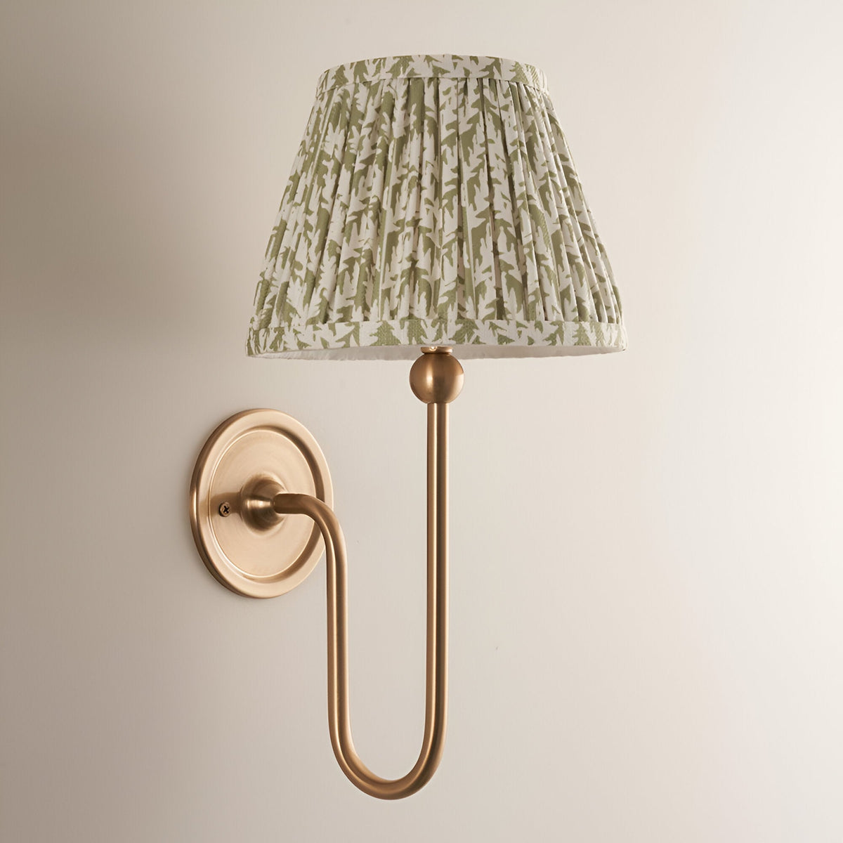 Cliffleigh Leaf Wall Light in Green, a single-arm wall light with brushed brass fitting and pleated green leaf-print fabric shade.