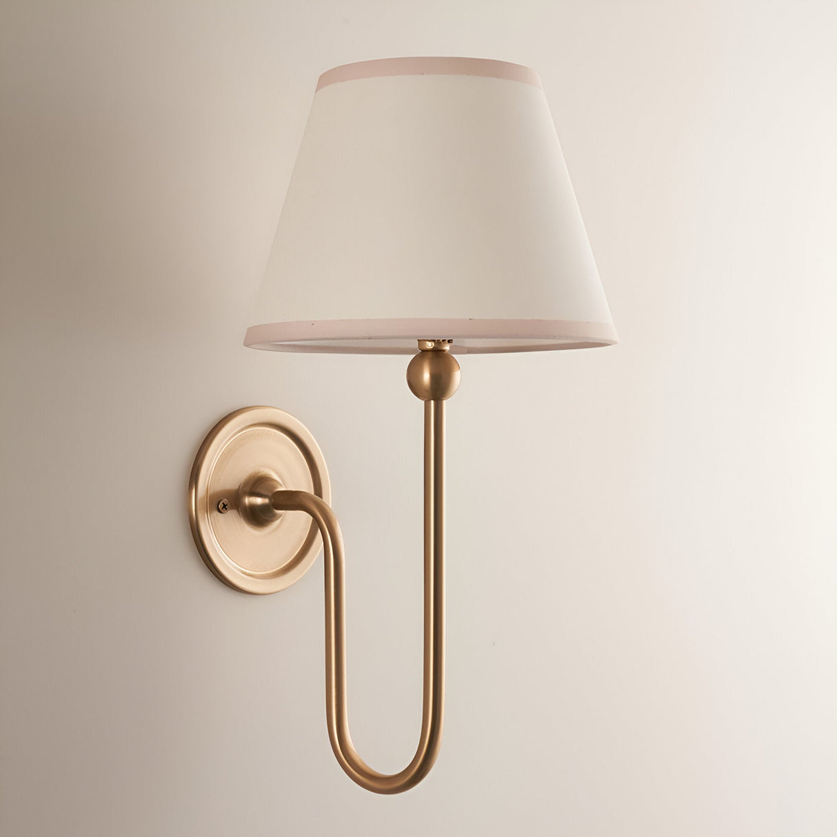 Cliffleigh Wall Light in Ivy, a brushed brass fitting with slim upright arm and tapered vintage white cotton shade, shown against a plain light background.
