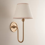 Cliffleigh Wall Light in Ivy, a brushed brass fitting with slim upright arm and tapered vintage white cotton shade, shown against a plain light background.
