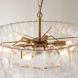 Close-up of the Carlwell 6 Light Pendant in brushed brass, showing curved glass pieces and E14 bulb fittings on a spider-arm frame.