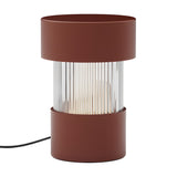 Balise Cylinder Ribbed Glass Lantern table lamp in terracotta, with a fluted glass centre between two iron bands, shown on a plain white background.