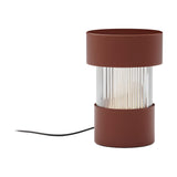 Balise Cylinder Ribbed Glass Lantern Table Lamp in terracotta, with iron top and base bands framing a fluted glass centre, shown on a plain white background.