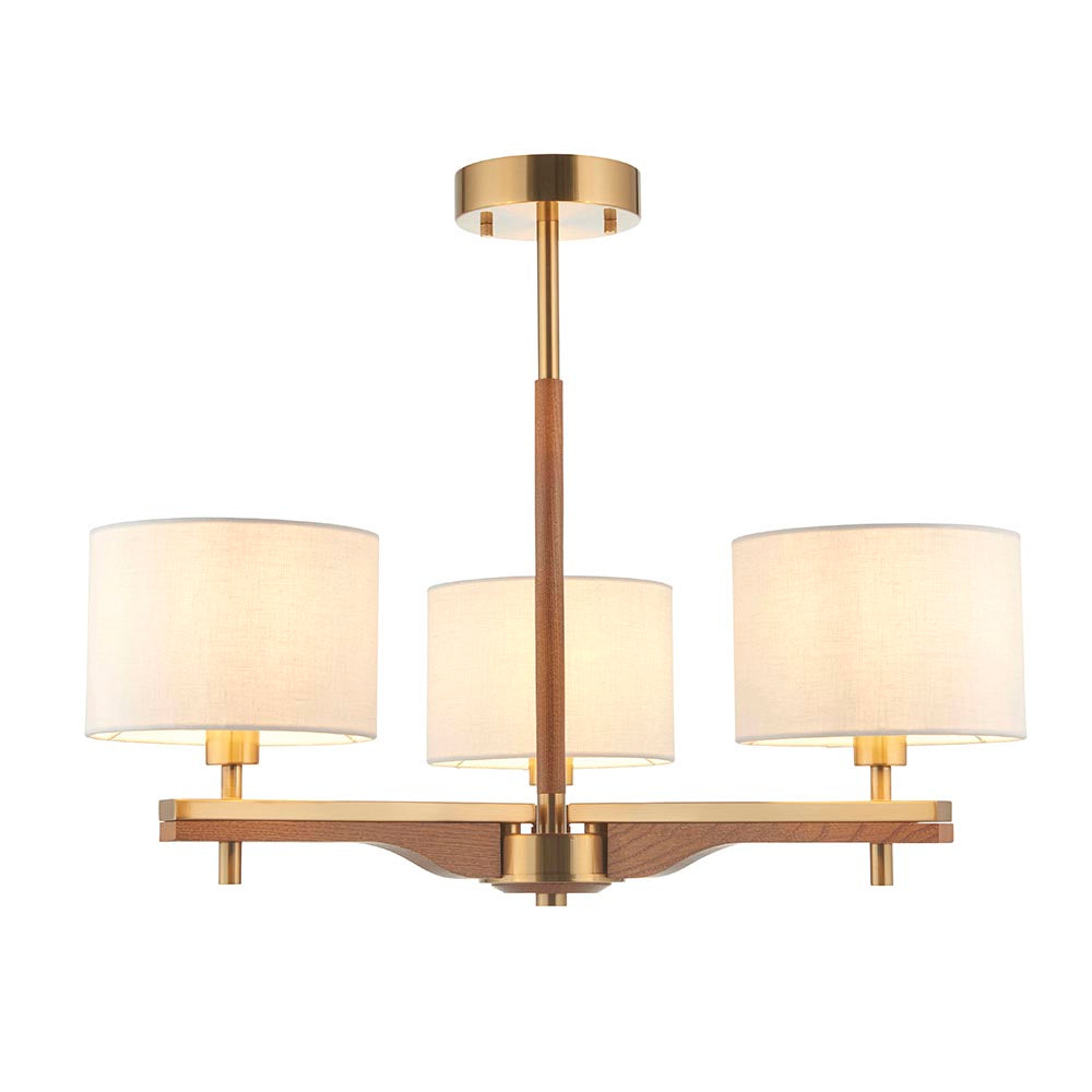 Bramwell 3-light semi-flush ceiling light with aged brass frame, oak arms and cream linen drum shades, on a plain white background.