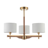 Bramwell 3 Light semi-flush ceiling light with aged brass frame, oak stem detailing and white linen drum shades on a plain white background.