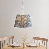 Brackmont Ripple Pendant in blue, a single-light fixture with a tapered fabric shade above a dining table with wooden chairs and place settings.