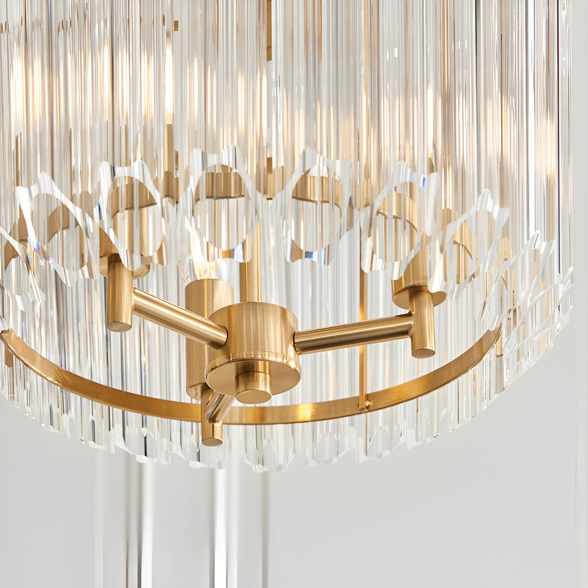 Close-up of Endon Danebury 3 Light Pendant showing brushed aged brass frame with tiered clear cut glass rods forming a faceted ring.