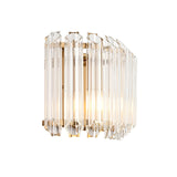 Endon Danebury wall light with faceted clear glass rods in a brushed aged brass frame, illuminated against a plain white background.