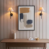 Endon Caldmere wall lights in black with tapered natural linen shades, mounted as a symmetrical pair on panelled wall above a wooden console with abstract art.