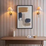 Pair of Endon Caldmere wall lights in antique brass with tapered natural linen shades, flanking a framed abstract print above a wood console table.