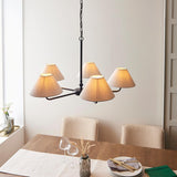Endon Caldmere 5 Light Large Pendant in black with natural linen tapered shades on a chain suspension, above a wooden dining table in a neutral room.