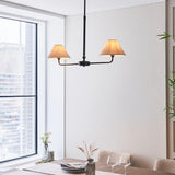 Endon Caldmere 2 light pendant with tapered natural linen shades on a slim black bar and telescopic stem, hung in a bright dining room by a window.