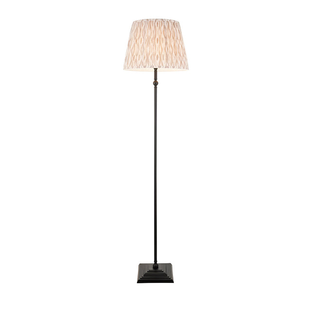Caldmere Ikat Floor Lamp in Natural with a pleated 40cm Ikat-print shade on a slender matt black stem and square base.