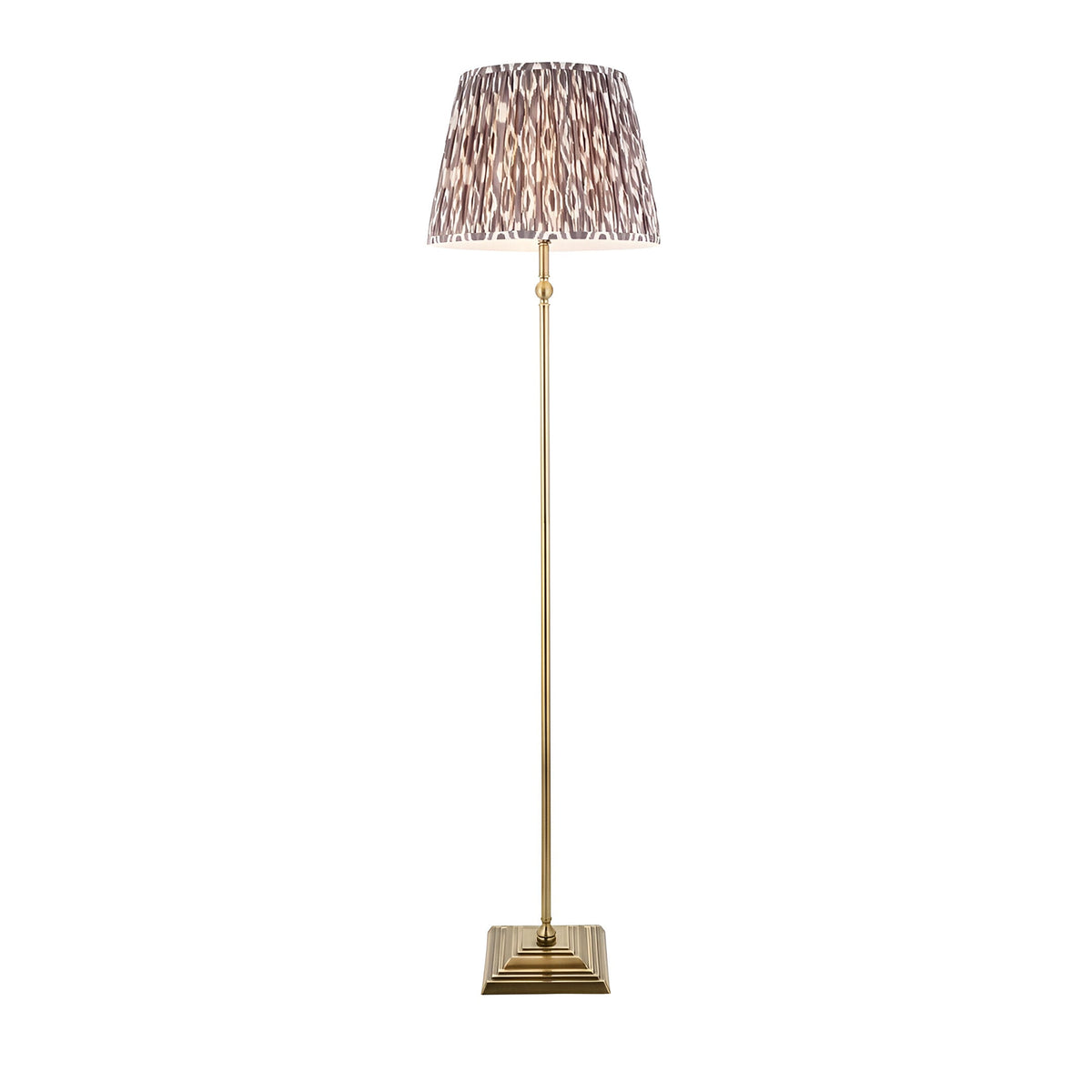 Caldmere Ikat Floor Lamp in Grey with antique brass stem, square base, and pleated grey Ikat-pattern fabric shade on a white background.