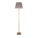 Caldmere Ikat Floor Lamp in grey with antique brass stem, square stepped base, and pleated Ikat-patterned fabric shade.