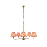 Endon Caldmere five light pendant with antique brass arms and tapered coral ikat pleated fabric shades, suspended from a chain on a white background.