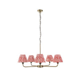 Endon Caldmere 5 light pendant with tapered coral pink ikat pleated shades on antique brass arms and chain, shown on a white background.